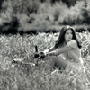 Female Model Sitting in Grass Field, Wearing Light Summer Dress