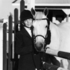 Female Model Posing with Her Horse In English Riding Clothes