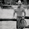 Shirtless Cowboy Male Model with Lanyard next to Rail Fence