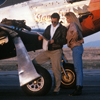 Male and Female Models Looking At Maps by the Wing
