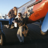 Male and Female Models Looking At Maps, Female Sitting on the Wing