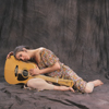 Maggie Simpson Posing with (and Hugging) Her Guitar